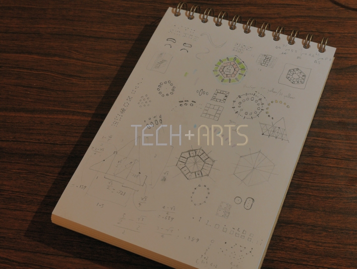 Notebook page with pencil sketches of watchface design ideas