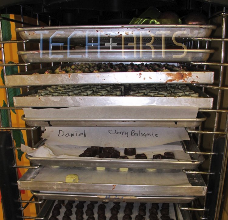 Standing rack containing trays of our chocolates amongst She's chocolates